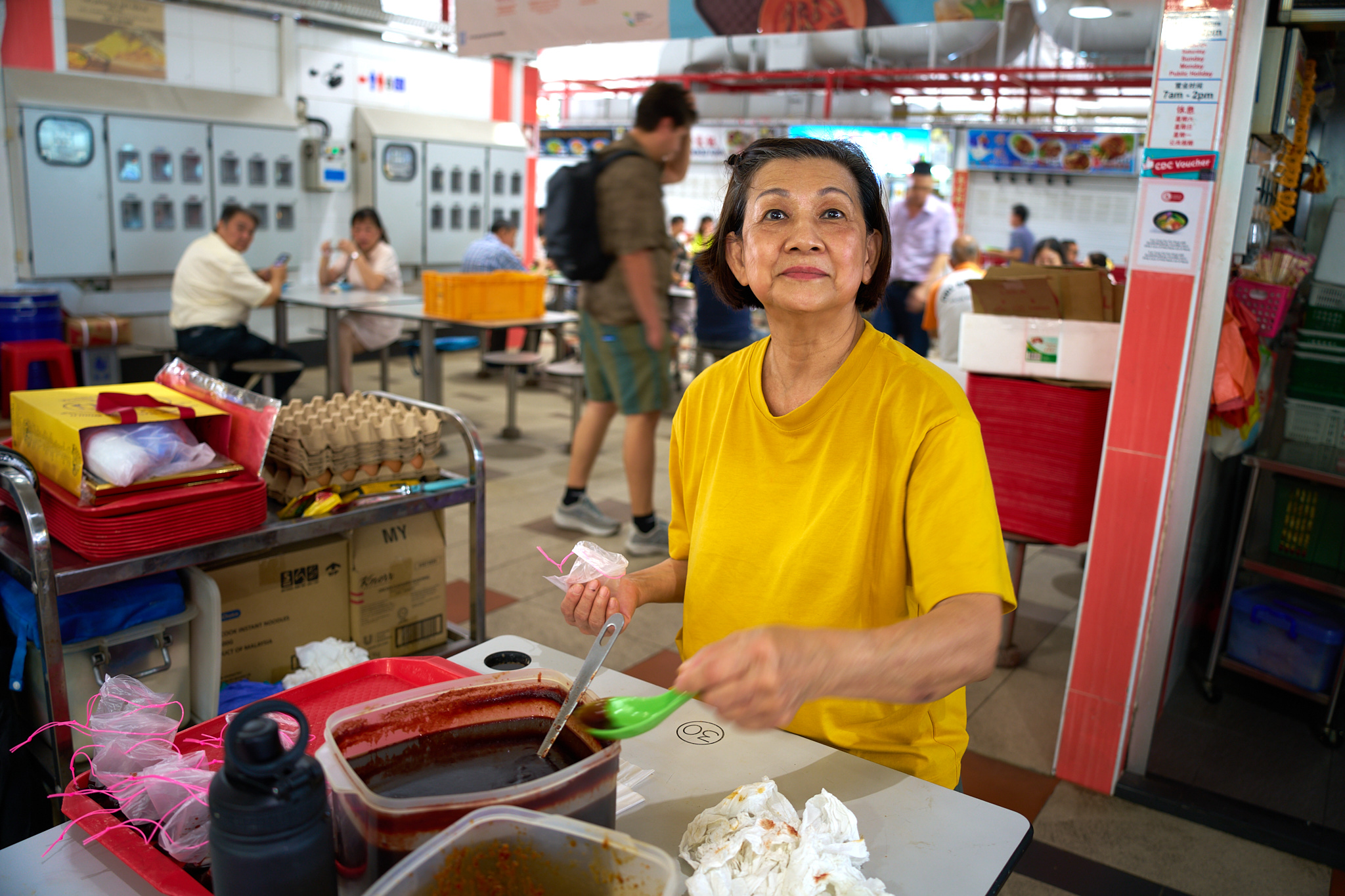 A hawker making the sauce for her food stall. 