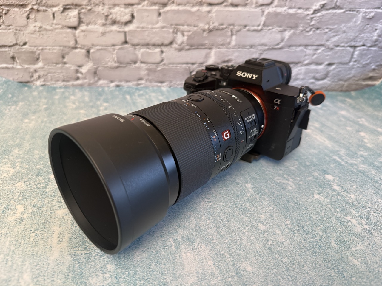 Sony 100mm macro on a blue table with white background