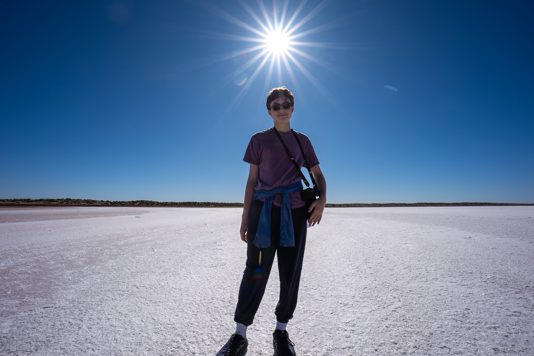 A teeanger standing on a salt flat in Australia.
